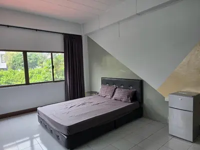 a bedroom with a bed and a large window at SRINN House, Bangkok in Bangkok