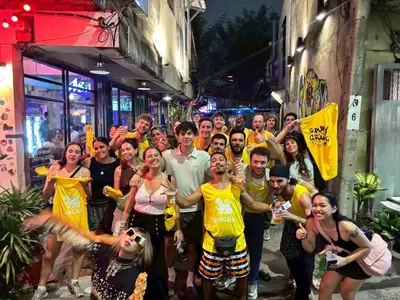 a group of people posing for a picture on a street at Here Hostel Bangkok in Bangkok