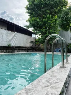 a swimming pool with a clear blue water at Here Hostel Bangkok in Bangkok