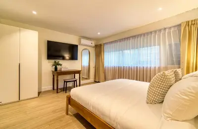 a hotel room with a bed and a desk at AB House in Bangkok
