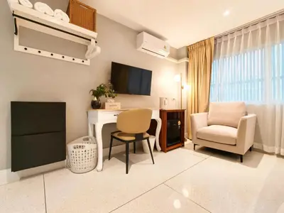 a living room with a desk and a chair at AB House in Bangkok