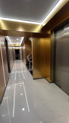 an empty hallway in a building with a lobby at Golden Mango home hotel \u91d1\u8292\u679c\u4e4b\u5bb6\u9152\u5e97 in Bangkok