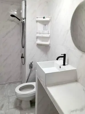a white bathroom with a sink and a toilet at Impact Arena Condo 2Rooms C3 by GoodRoom24 in Ban Bang Phang