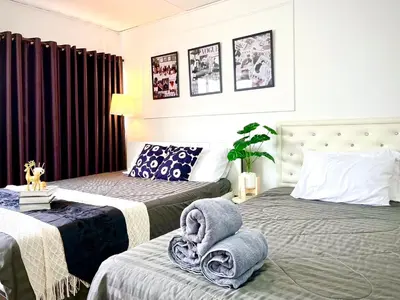 a bedroom with two beds with towels on them at Impact Arena Condo Twin Beds by Goodroom24 in Ban Song Hong
