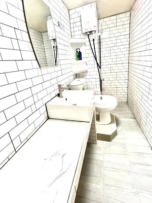 a white bathroom with a sink and a toilet at Impact Arena Condo Twin Beds by Goodroom24 in Ban Song Hong