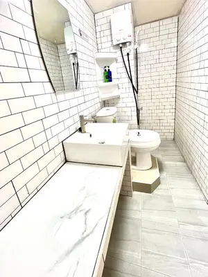 a white bathroom with a sink and a toilet at Impact Arena Condo Twin Beds by Goodroom24 in Ban Song Hong