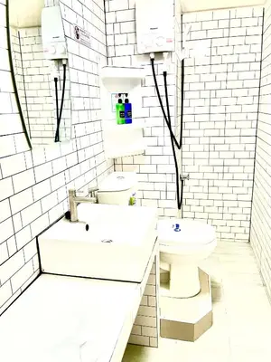a white bathroom with a sink and a toilet at Impact Arena Condo Twin Beds by Goodroom24 in Ban Song Hong
