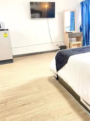 a bedroom with a bed and a flat screen tv at Impact Arena Condo 6fl by GoodRoom24 in Ban Song Hong