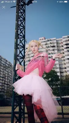 a woman in a pink dress standing on a pole at Impact Arena C8 Condo by GoodRoom24 in Thung Si Kan