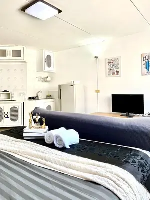 a room with a bed with towels on it at Impact Arena Condo C1 by GoodRoom24 in Ban Song Hong