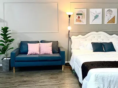 a bedroom with a bed and a blue chair at Impact Arena Condo C3 Grey by GoodRoom24 in Ban Bang Phang