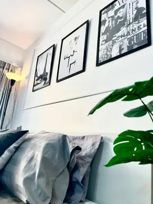 a living room with a couch and pictures on the wall at Impact Arena Condo C3 by GoodRoom24 in Ban Bang Phang