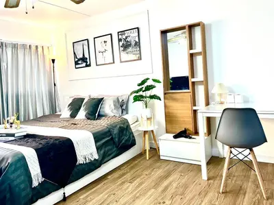 a bedroom with a bed and a desk and a chair at Impact Arena Condo C3 by GoodRoom24 in Ban Bang Phang