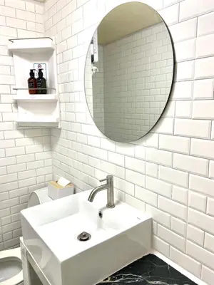 a white bathroom with a sink and a mirror at Impact Arena Condo C9 by GoodRoom24 in Pak Kret