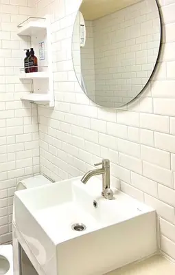 a white bathroom with a sink and a mirror at Impact Arena Condo C9 by GoodRoom24 in Pak Kret