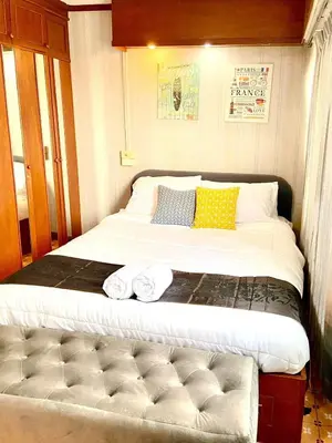 a large bed in a room with two towels on it at Impact Arena Condo The Classic by GoodRoom24 in Ban Song Hong