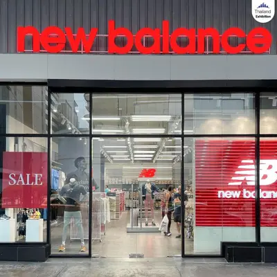 a new balance store with people walking inside of it at Impact Arena Condo The Classic by GoodRoom24 in Ban Song Hong