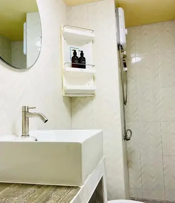 a white bathroom with a sink and a shower at Impact Arena Condo TwoTone By GoodRoom24 in Ban Song Hong