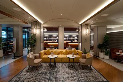 a lobby with a yellow couch and two tables and chairs at Four Points by Sheraton Bangkok, Sukhumvit 22 in Bangkok