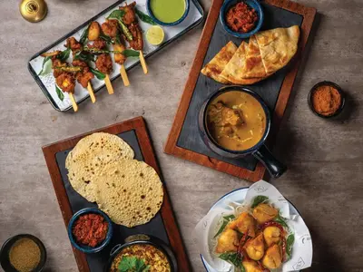 a table topped with different types of food on plates at Four Points by Sheraton Bangkok, Sukhumvit 22 in Bangkok