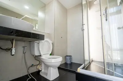 a bathroom with a toilet and a sink and a shower at Spacious 3BR near Impact, Don Mueang Airport & Pink Line MRT in Nonthaburi