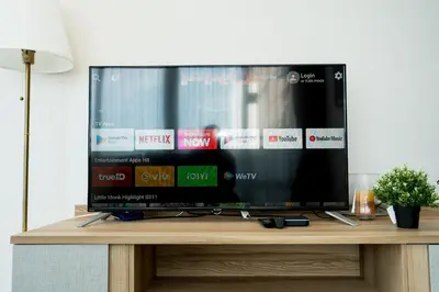 a flat screen tv sitting on top of a wooden table at Spacious 3BR near Impact, Don Mueang Airport & Pink Line MRT in Nonthaburi