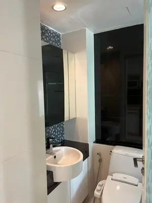 a bathroom with a white toilet and a sink at Apartment in Central Sukhumvit in Bangkok