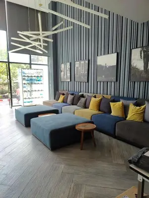 a living room with a blue couch and a table at Cozy Apartment Night Market and Shopping Mall at MRT Purple Line in Nonthaburi