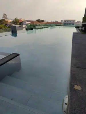 a view of a pool with stairs on a roof at Cozy Apartment Night Market and Shopping Mall at MRT Purple Line in Nonthaburi