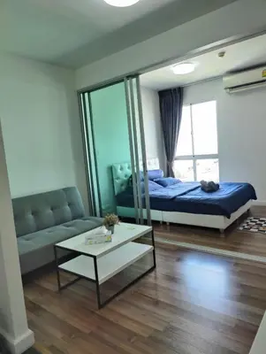 a bedroom with a bed and a couch and a table at Cozy Apartment Night Market and Shopping Mall at MRT Purple Line in Nonthaburi