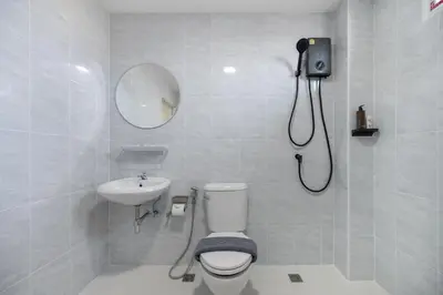 a bathroom with a shower and a toilet and a sink at Arun Sa wad - Chinatown in Bangkok