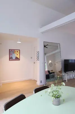 a white room with a table and a couch at House 33 in Bangkok