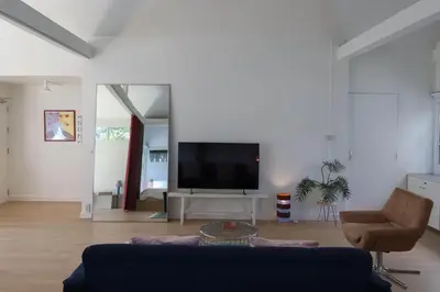 a living room with a couch and a flat screen tv at House 33 in Bangkok