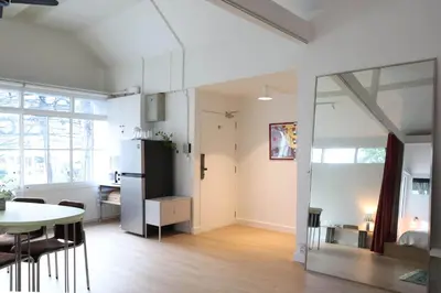 a kitchen and living room with a table and a refrigerator at House 33 in Bangkok