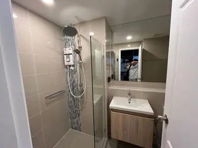 a bathroom with a shower and a sink at Cybiq Ratchada 32 By OBM in Ban Zong Katiam