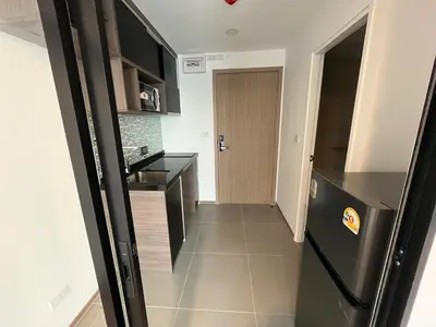 a kitchen with a black refrigerator in a room at Cybiq Ratchada 32 By OBM in Ban Zong Katiam