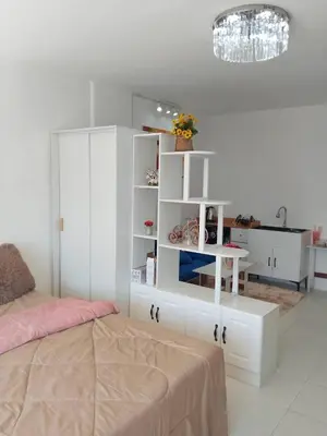a bedroom with a bed and a white book shelf at City villa condo - Cozy budget flat in LadPhao rd, Bangkapi in Ban Bang Toei (1)