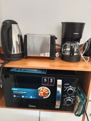 a microwave and a coffee maker on a shelf at City villa condo - Cozy budget flat in LadPhao rd, Bangkapi in Ban Bang Toei (1)