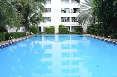 a large blue swimming pool in front of a building at City villa condo - Cozy budget flat in LadPhao rd, Bangkapi in Ban Bang Toei (1)