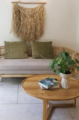a living room with a couch and a coffee table at baan nuit Bangkok Stayhouse in Bangkok