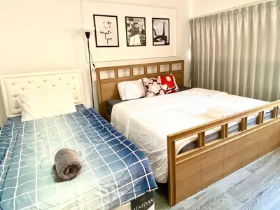 a bedroom with two beds and a stuffed animal at Impact Arena C3 Twin Beds By GoodRoom 24 in Ban Bang Phang