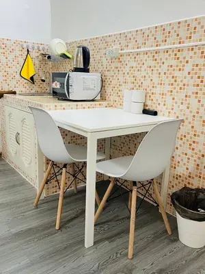 a white table and two chairs in a kitchen at Impact Arena C3 Twin Beds By GoodRoom 24 in Ban Bang Phang