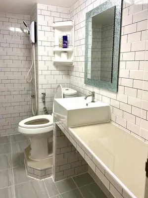 a white bathroom with a sink and a toilet at Impact Arena C3 Twin Beds By GoodRoom 24 in Ban Bang Phang