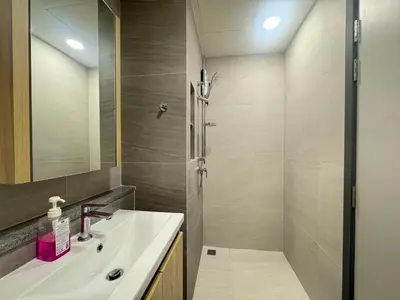 a bathroom with a sink and a shower at Neon Cloud Bangkok in Bangkok