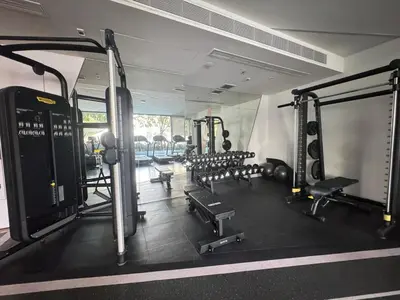 a gym with several treadmills and machines in it at Neon Cloud Bangkok in Bangkok