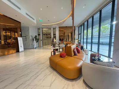 a lobby with a couch in the middle of a building at Neon Cloud Bangkok in Bangkok