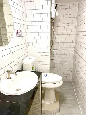 a white bathroom with a sink and a toilet at Impact Arena C75fl by GoodRoom24 in Ban Song Hong