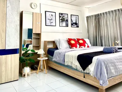 a bedroom with a bed with red pillows at Impact Arena Condo C7 fl12 By GoodRoom24 in Ban Song Hong