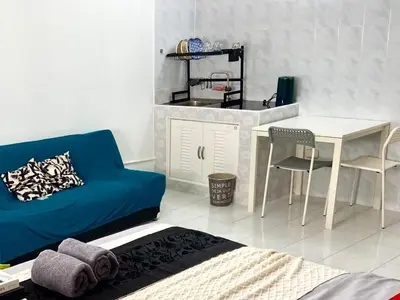 a living room with a blue couch and a table at Impact Arena Condo C7 fl12 By GoodRoom24 in Ban Song Hong
