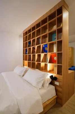 a bedroom with a bed with a wooden headboard at The companions house in Sathani Bang Su